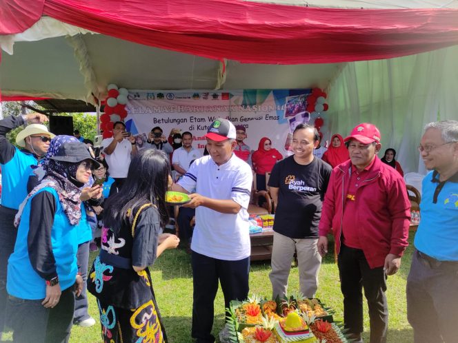 
Teks foto : Asisten II Setkab Kukar, Ahyani saat memberikan potongan tumpeng kepada salah satu anak (angga/okeborneo.com) 