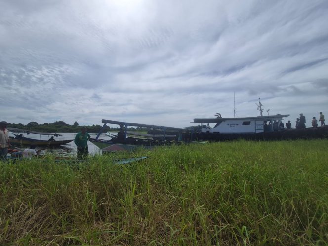 
Warga Desa Pela bergotong royong membersihkan tumpukan gulma air yang menghambat jalur perairan dan aktivitas nelayan. (Foto: Alimin Azarbaijan)