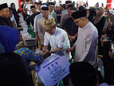 Wakil Bupati Kukar Rendi Solihin menyerahkan bantuan secara simbolis kepada warga pada kegiatan buka puasa bersama di Kuala Samboja. (Istimewa)